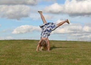 IELTS Energy 1573 - Childhood on IELTS Part 2 - Boundless Energy for Speaking Part 2 Kid doing cartwheels